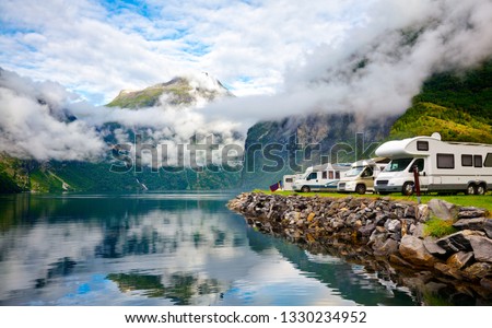 Camper van recreational vehicles (RV) parked at norwegian campsite on a fjord coast, Norway, Scandinavia