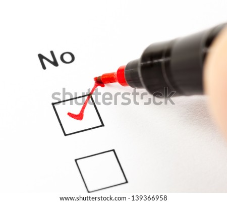 Hand with red pen marks the check box No