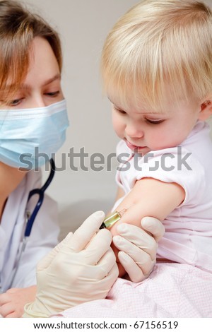 Doctor giving a child an intramuscular injection in arm