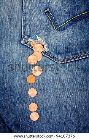 Money fall down from a hole in jeans pocket