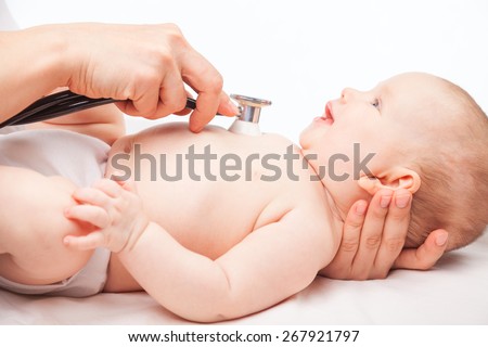 Close-up shot of pediatrician examines three month baby girl. Doctor using a stethoscope to listen to baby\'s chest checking heart beat