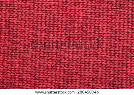 Real red knitted fabric made of heathered yarn textured background