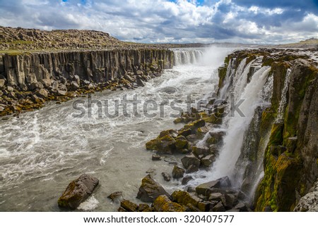 Selfoss is a horseshoe-shaped waterfall on the glacier river Jokulsa a Fjollum situated a few hundred meters upstream from the Dettifoss waterfall.