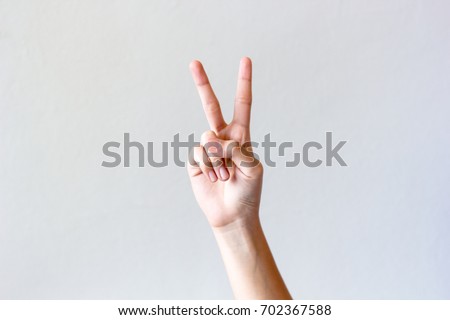 Image, Stock Photo Female palm with V-sign with rainbow bracelet