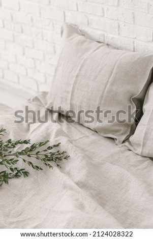 Bed linen and eucalyptus on white background. Natural. Eco-friendly fabric. Cozy interior. Gray pillowcase and blanket made of natural linen. Space for text Foto stock © 