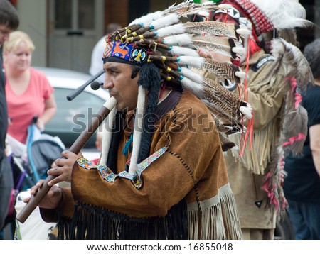 SKEGNESS, ENGLAND - AUG 23: Native American Indian tribal group play music, sing and dance to entertain shoppers in Skegness, England on 23 Aug 2008
