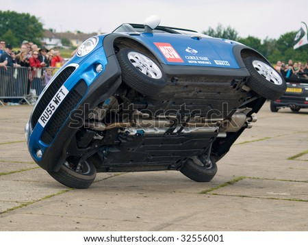GRIMSBY, ENGLAND - JUNE 21: Stunt car driver Russ Swift entertains the crowds in his Mini Cooper at the New Mini Day, Manby Park,Grimsby in aid of Help For Heroes Charity, June 21 2009
