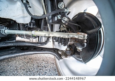Pre purchase inspection or pre delivery diagnostic view of the new car bottom, chassis and suspension. Garage service, flat tire repair, wheel alignment, steering adjustment. Imagine de stoc © 