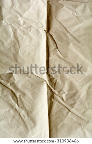 Texture of crumpled paper. Yellow brown paper sheet. Crumple and wrinkle background.
