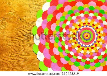 Background or holiday card with decorative handmade paper flower like circle mandala on gold background with space for text, isolated.