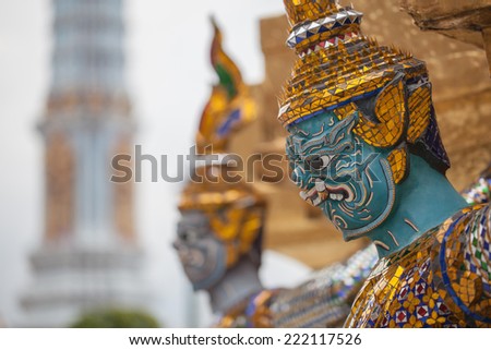 The statue of Thai demon carrying the golden pagoda at Wat Phra Kaew, Temple of the Emerald Buddha, Bangkok, Thailand