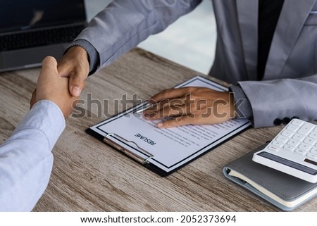 An employer shakes hands of a male job applicant congratulating the position. The HR manager is happy to hire job applicants to shake hands. A good interview idea that succeeds in a friendly manner le Photo stock © 