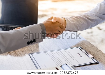 An employer shakes hands of a male job applicant congratulating the position. The HR manager is happy to hire job applicants to shake hands. A good interview idea that succeeds in a friendly manner le Photo stock © 