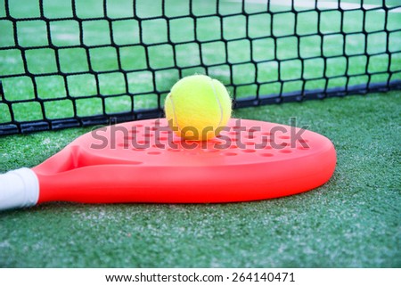 paddle tennis racket and ball in paddle tennis field