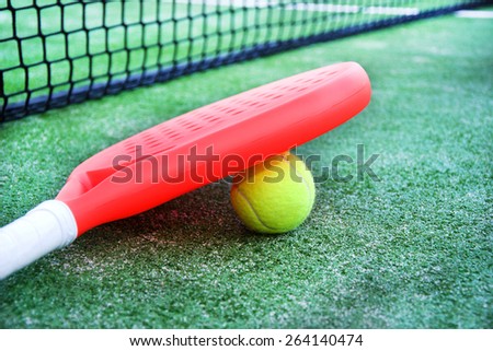 paddle tennis racket and ball in paddle tennis field