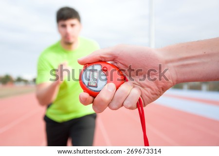 Runner and timer in running track