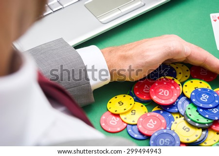 man with poker chips in hands