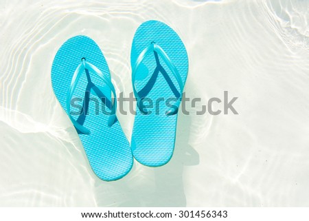summer shoes afloat in the swimming pool