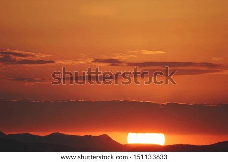 The sun sets over the waters and islands of Lake Malawi, Malawi, Africa.