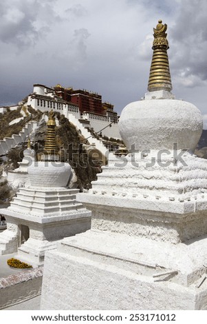 A pair of stupas in front overlook the Potala Palace, the residence of the exiled Dalai Lama in Lhasa, the capital of Tibet.