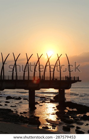 The sun rises over the Umhlanga Pier in Durban, South Africa.