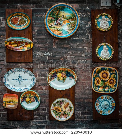 SIENA, ITALY - MARCH 29, 2014: Handmade plates in small souvenir shop in the old city of Siena, Tuscany region, Italy