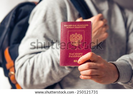 Tourist person holds russian passport. Toned picture