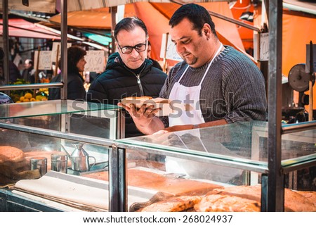 PALERMO, ITALY - MARCH 13, 2015: Street food vendor at famous local market Ballaro in Palermo, Italy