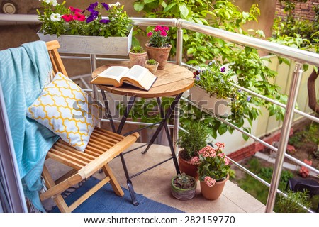 Beautiful terrace or balcony with small table, chair and flowers