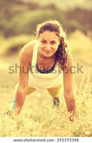 Young woman doing push ups workout. Wellness and sport concept. Toned image