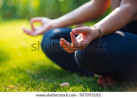 Yoga meditation in park, healthy female in peace, soul and mind zen balance concept. Selective focus and shallow DOF