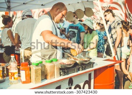 MOSCOW, RUSSIA - AUGUST 9, 2015: Street vendor is making chilli con carne at a street fair n Moscow, Russia. Toned picture, vintage film effect