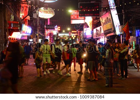 PATTAYA, THAILAND - FEBRUARY 18, 2017 - multicolored neon signs and people on the new Walking Street of the city