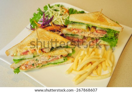 club sandwich, sandwich stuffed with meat and vegetable served with french fries