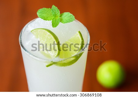 lime juice shake close-up with a lime on background