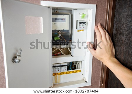 energy meter and electricity switch box indoors. repair and adjust domestic power wires and equipment. electrician repair service concept. ストックフォト © 
