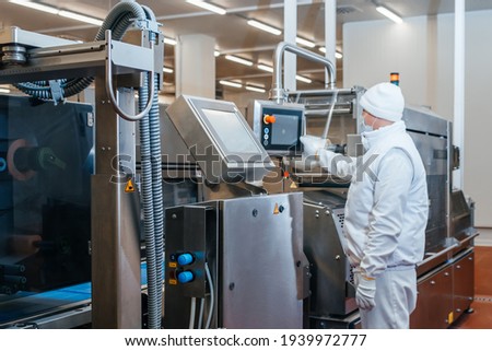 Meat processing plant. Production line of meat.Line for the production of meat with packaging and cutting . Industrial equipment at a meat factory.