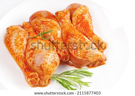 Baner.Cooking chicken drumsticks.Raw chicken legs in a marinade with rosemary on a background.Marinated chicken dramstick with spices for cooking.Top view, copy space.Isolated Stock fotó © 