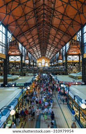 BUDAPEST, HUNGARY - JUNE 6: Vertical view of the central hall of the Great Market Hall in Budapest, Hungary, full of locals and tourist buying form the different stalls, on June 6, 2015.