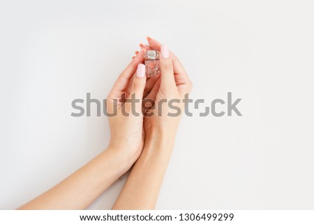 small bottle of perfume in female hands. Little aroma bottle in woman's hands/ Arome therapy Stock fotó © 