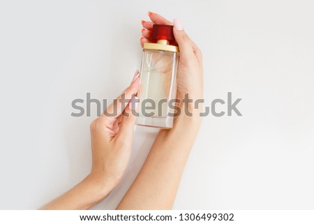 bottle of toilet water or cologne in female hands. Aroma bottle in woman's hands. Arome therapy Stock fotó © 