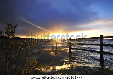 setting sun bursts through,clouds,wind and rain at Lough Ennell, Co.Westmeath, Ireland