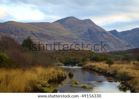 stream running through mountains in Co.Kerry,Republic Of Ireland with Knockatee Mountain in Background