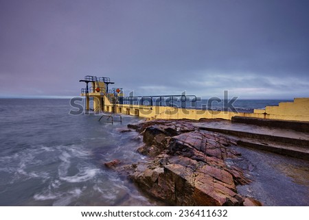 Blackrock Diving Tower is a pier with several diving platforms at different levels and is located at the end of Salthill\'s promenade with Galway Bay in the background