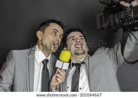 Two men with camera and microphone