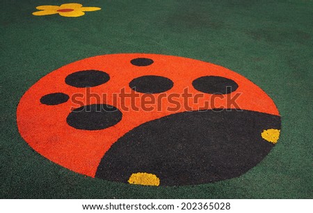 Floor covering children\'s playground with a ladybug