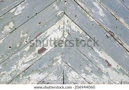 Old wooden boards nailed as herringbone pattern