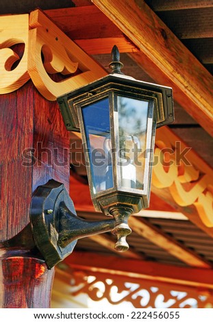 The lantern on the wall decorated with wooden carvings