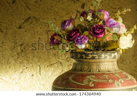 Still life. Beautiful rose in old clay vase
