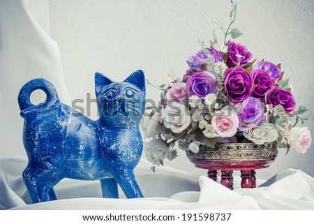 A handmade wooden sculpture of cat painted by hand. Still life.